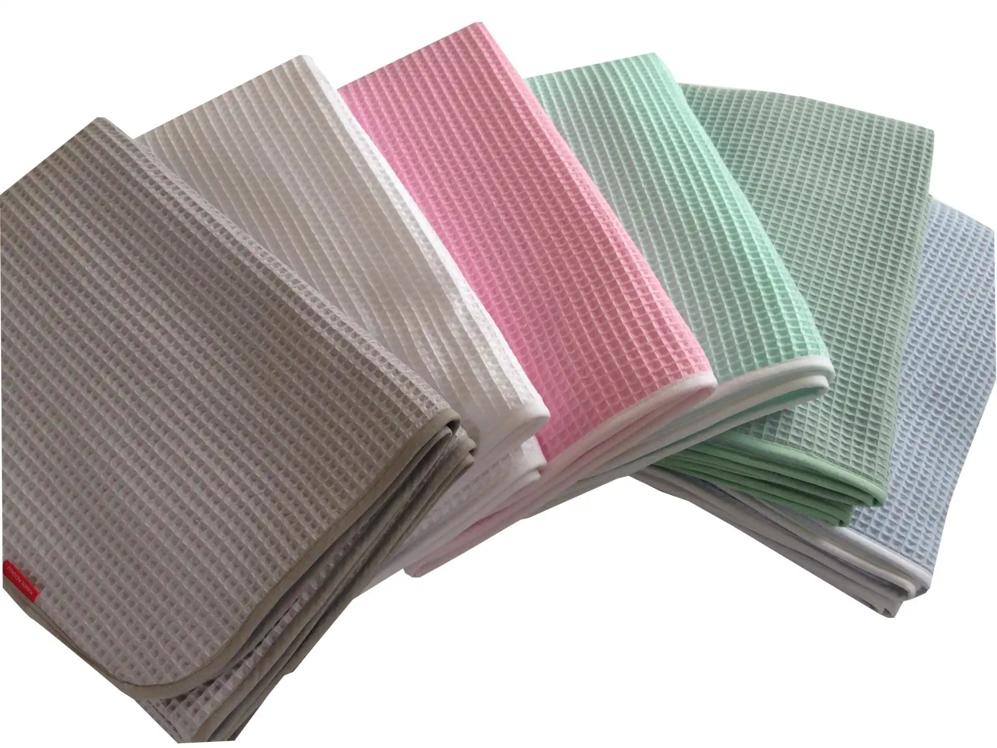 Een stapel wafelkatoen afwasdoekjes in verschillende pastelkleuren.